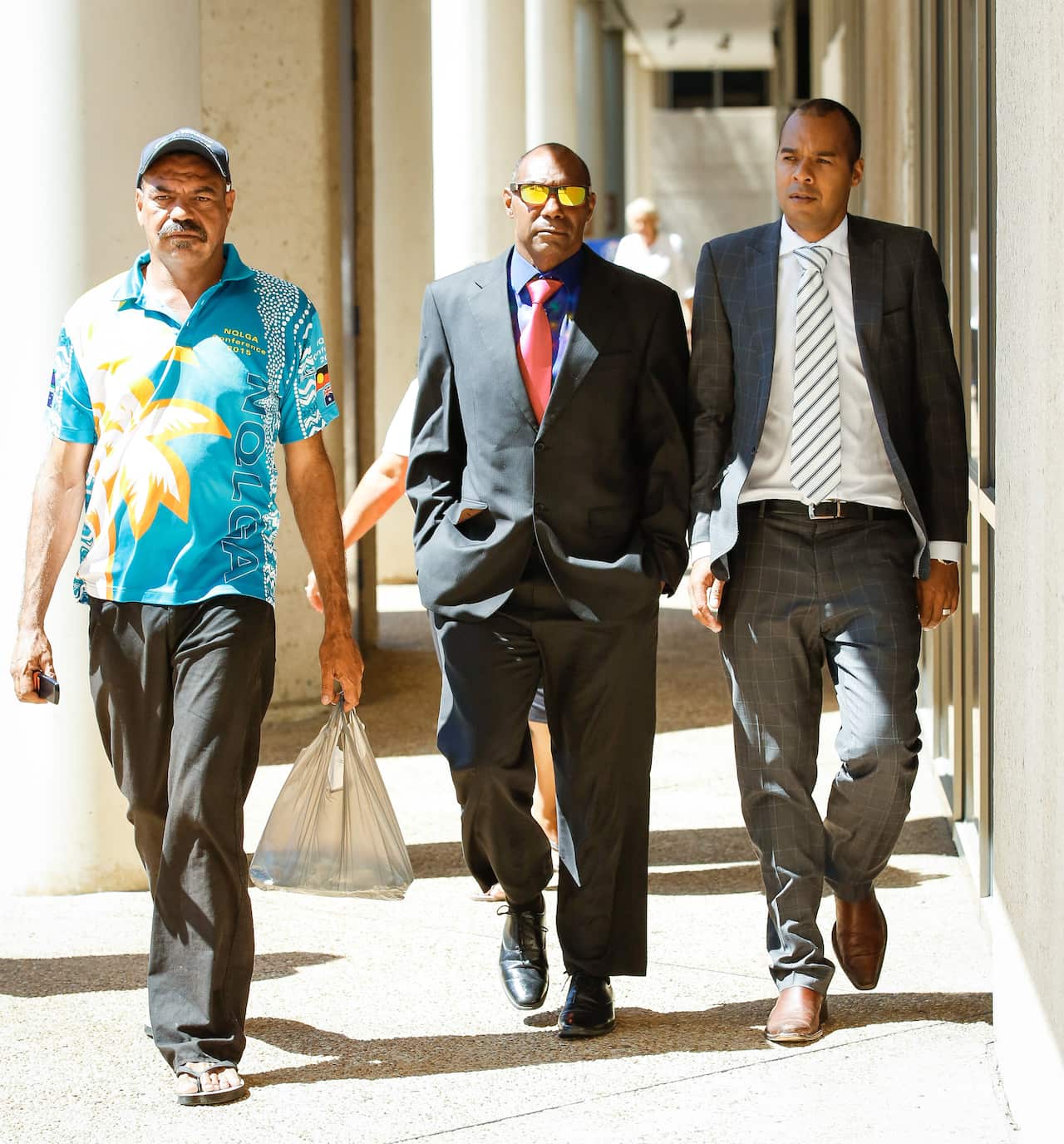 Lex Wotton (centre) his brother Anthony Wotton, (left) and his barrister Josh Creamer arriving at the Federal Circuit Court in Townsville to give evidence.