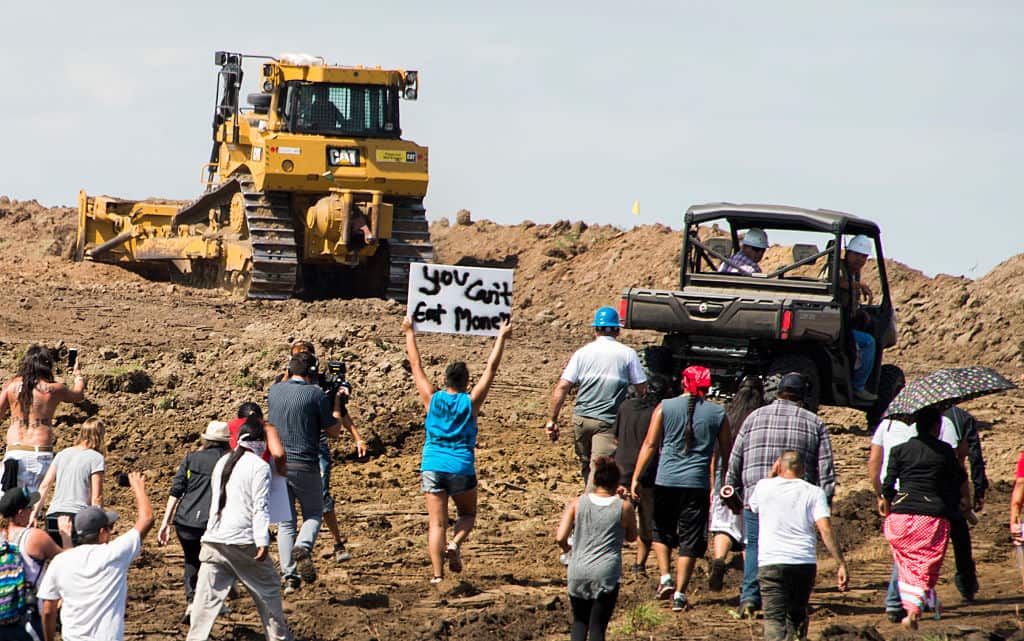 Native American protestors and their supporters are confronted by security during a demonstration against work being done for the Dakota Access Pipeline.