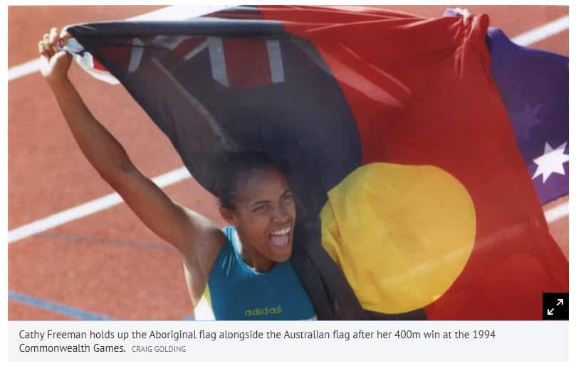 Cathy Freeman holds up the Aboriginal flag after her 400m win at the 1994 Commonwealth Games