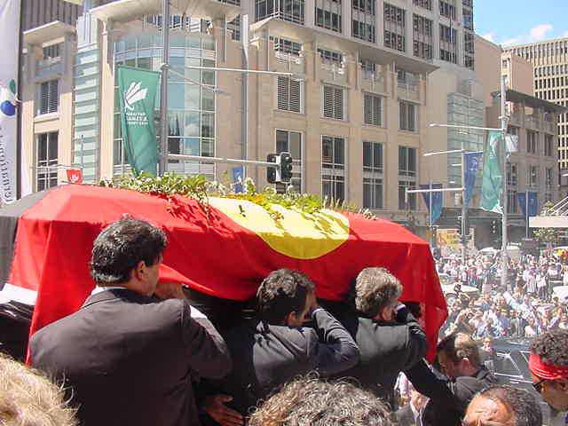 Coffin bearers outside town hall.
