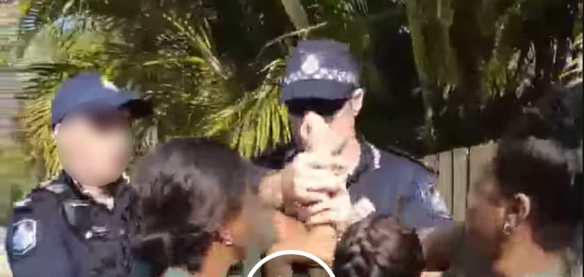 Girls arm held by Police