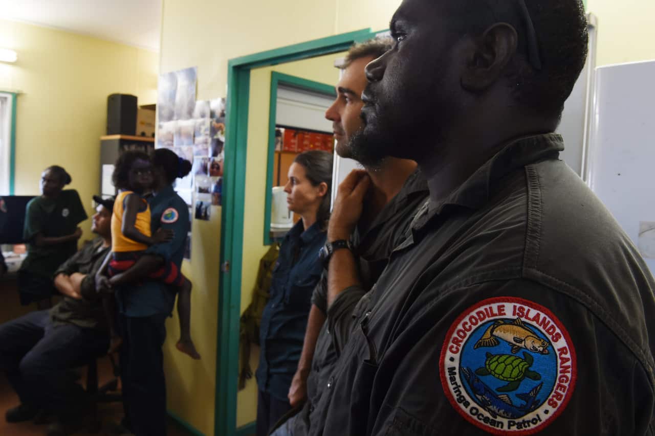 Members of the Crocodile Islands Rangers listen as Senator Nigel Scullion launches CDP in Milingimbi.