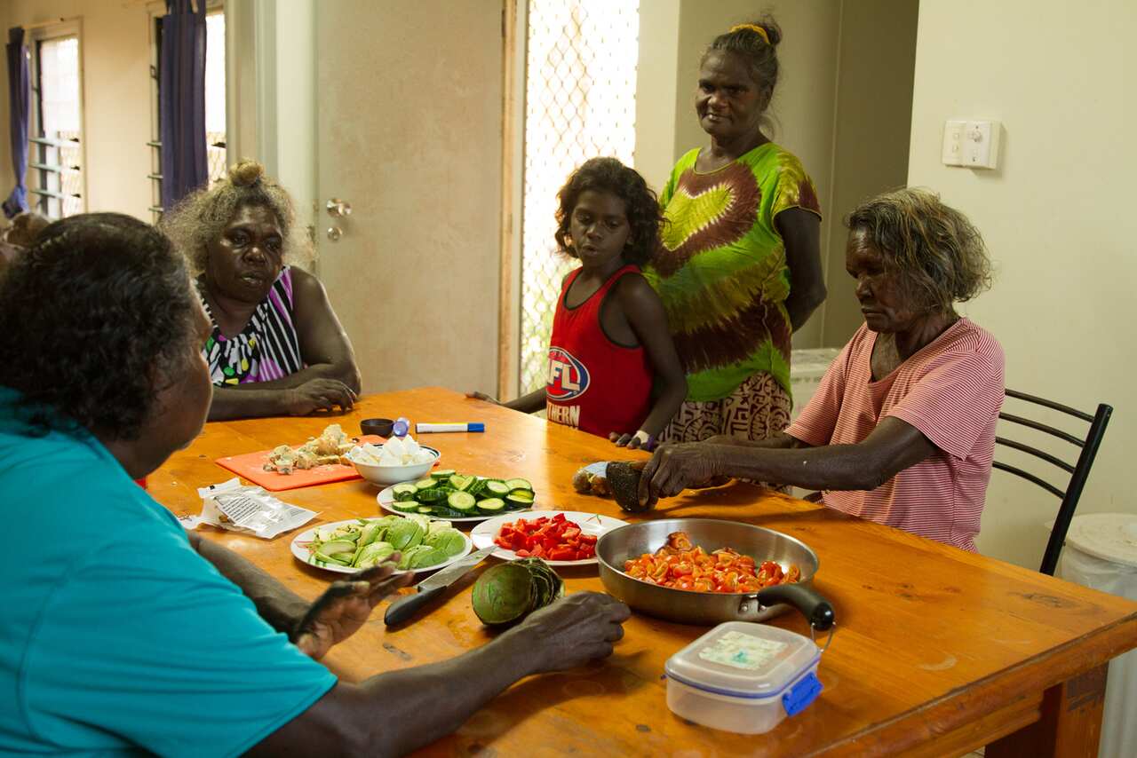Women prepare a health meal at home.