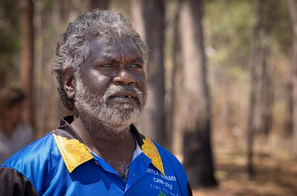 Dennis Tipakillipa standing amongst trees