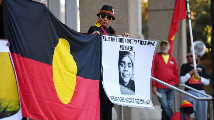 A woman stands during a protest over the death of 14-year-old Elijah Doughty in Kalgoorlie outside the Supreme Court in Monday, July 24, 2017. (AAP Image/David Moir) NO ARCHIVING