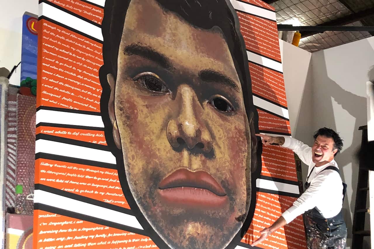 Blak Douglas with his finished portrait of Dujuan Hoosan.