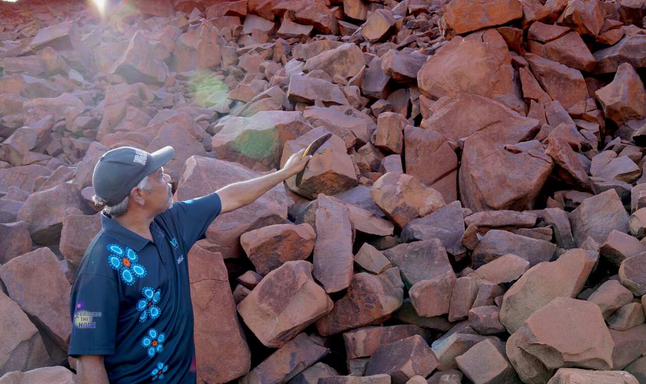Ngarlama Yindjibarndi man Patrick Churnside with the Murujuga rock engravings