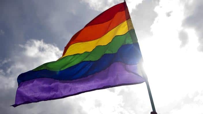 A reveller waves a rainbow flag during the Gay Pride Parade in Medellin, Antioquia department, Colombia on June 30, 2013. AFP PHOTO/Raul ARBOLEDA        (Photo credit should read RAUL ARBOLEDA/AFP/Getty Images)
