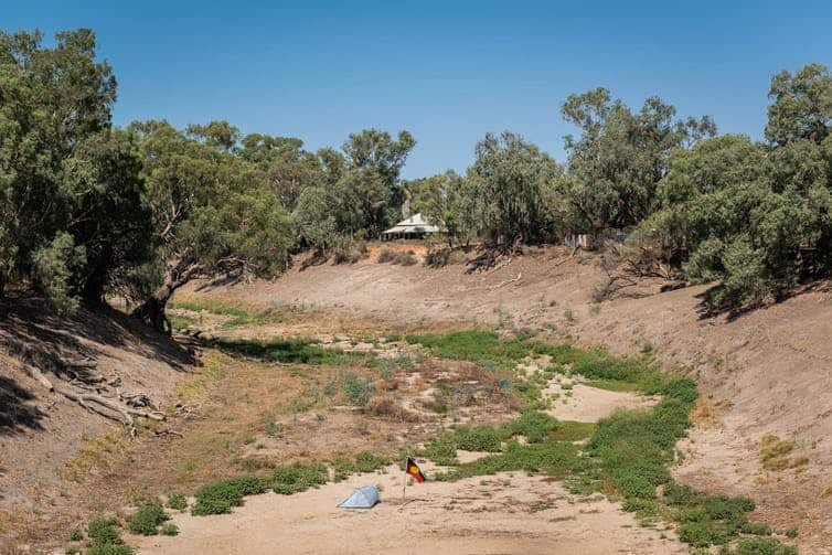 A view from the highway bridge at Wilcannia of the Aboriginal Tent Embassy on the Darling River, set up on the day of action in March 2019.