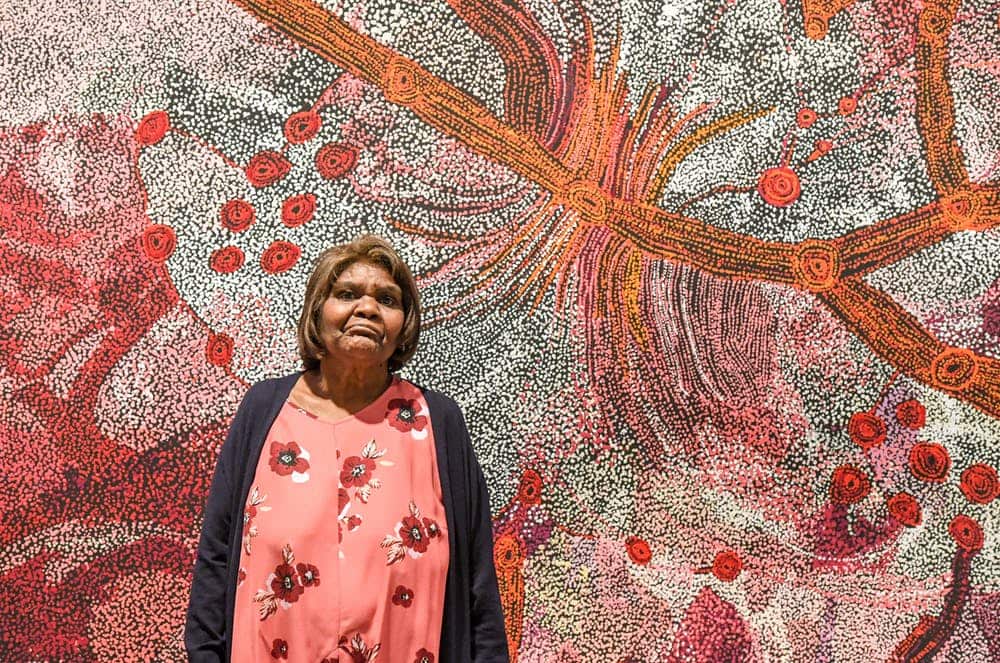 Sylvia Ken, winner of the 2019 Wynne Prize, with her painting of the Seven Sisters at the Art Gallery of NSW in May. Peter Rae/AAP
