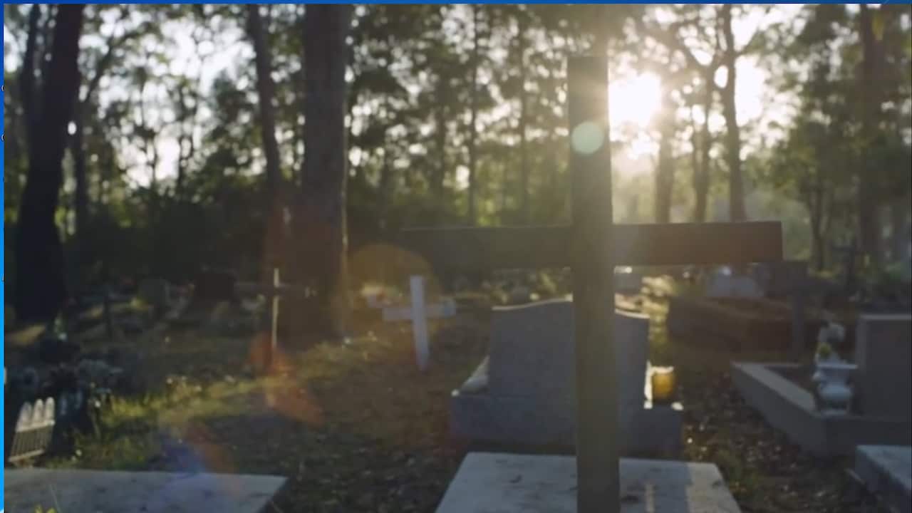 a grave yard with crosses and gravestones