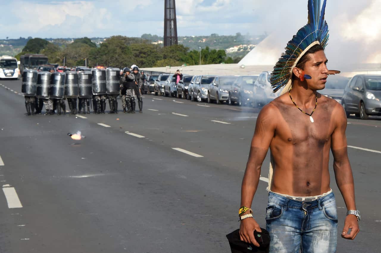 A Brazilian indigenous man clashes with police during the annual march for their rights, in Brasilia, on April 25, 2017.