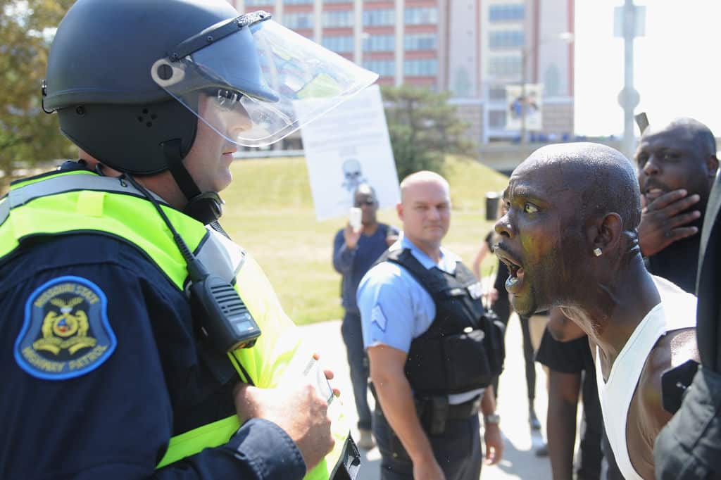  A man yells at a law enforcement officer during a protest action following a not guilty verdict on September 15, 2017 in St. Louis, Missouri.