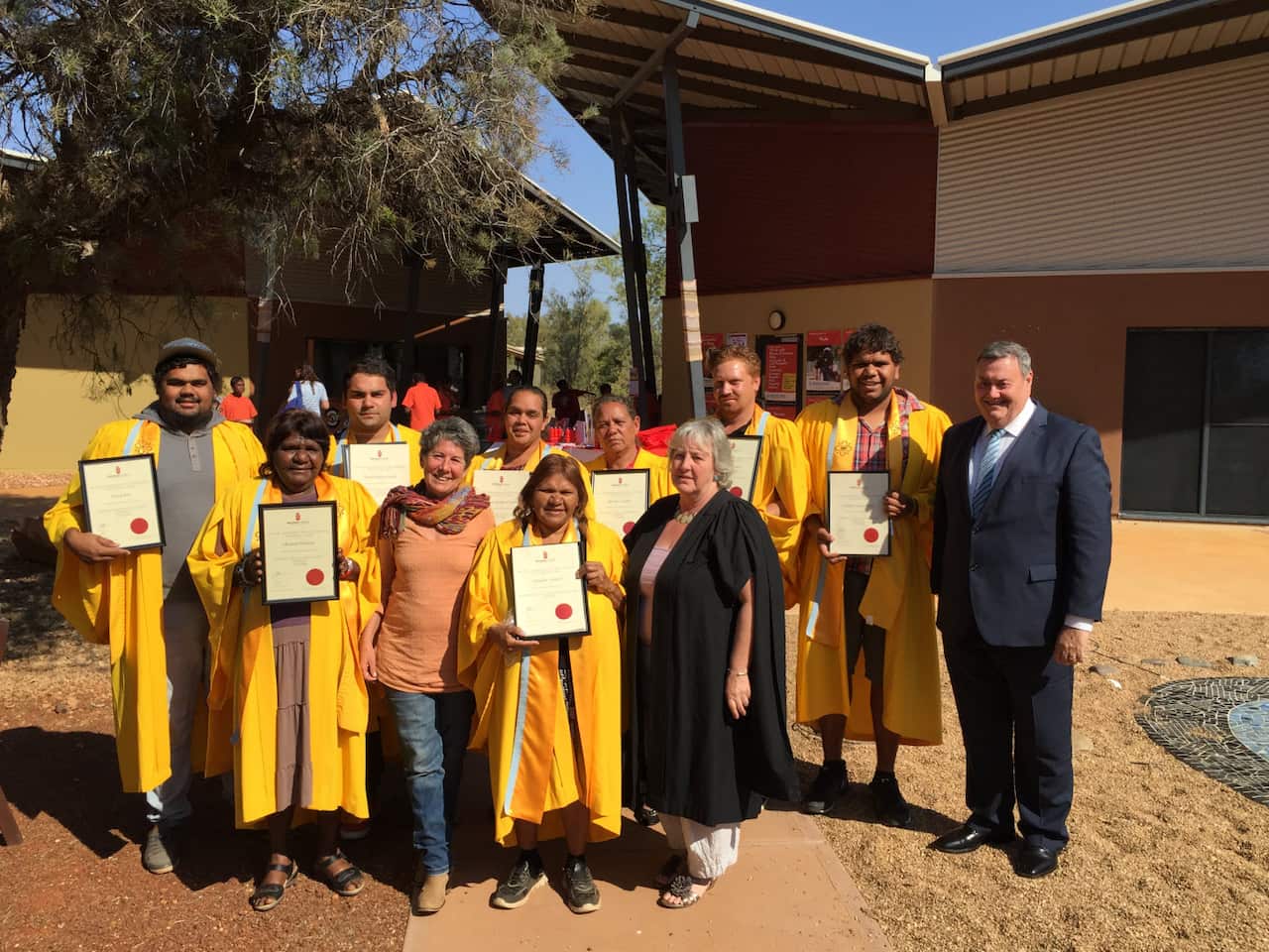 Batchelor Institute graduates with their lecturers and Alice Springs Mayor Damien Ryan (right).