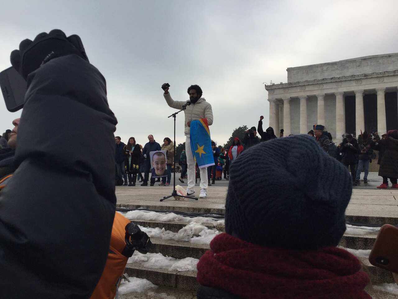 Australian Heritier Lumumba, a former AFL footballer of Brazilian and Congolese descent, addresses the gathering at the Indigenous Peoples March.