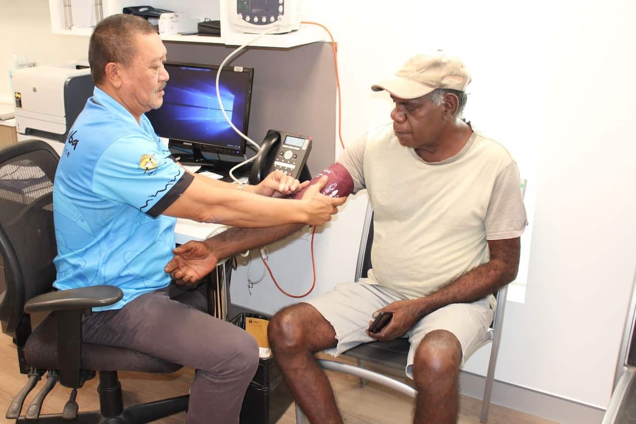 A man receives a health check at Danila DIlba health service.