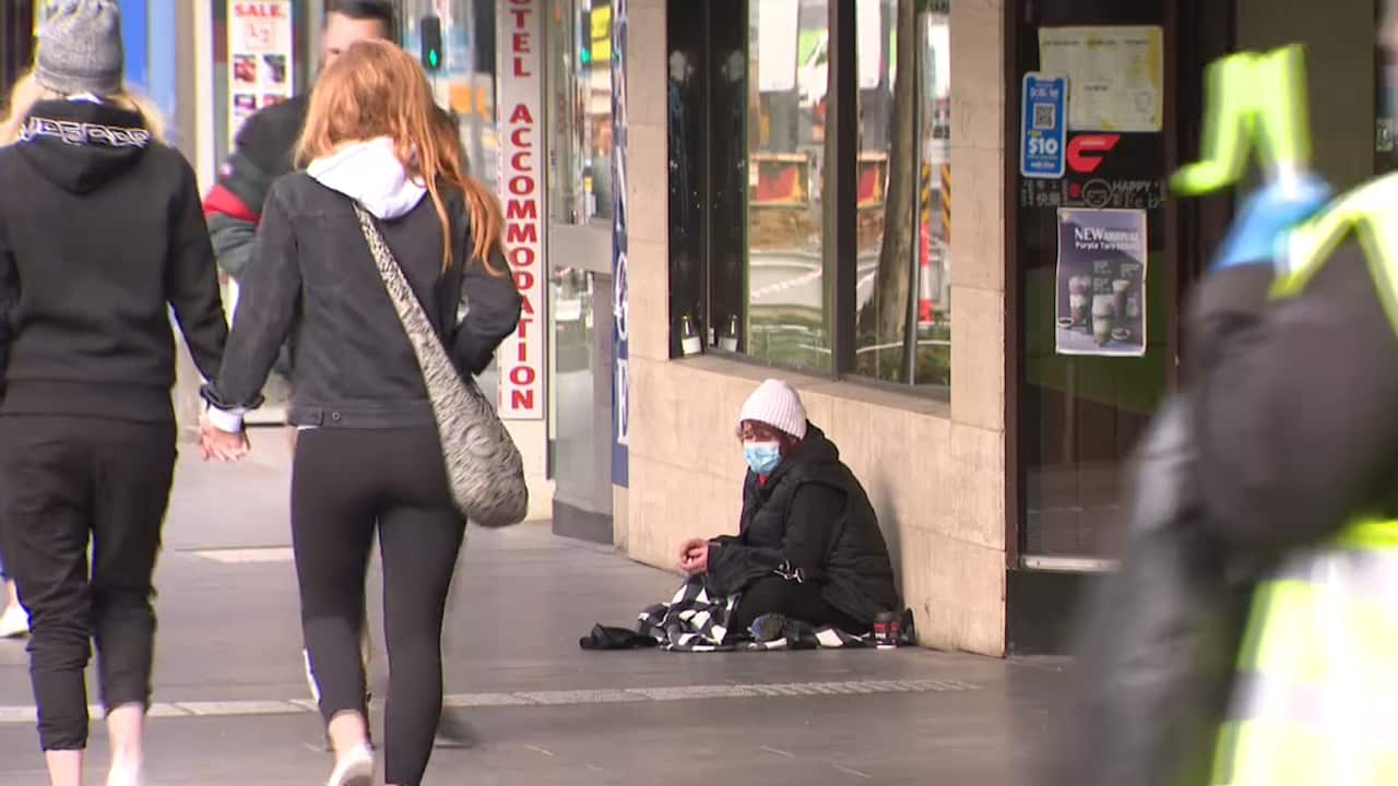 A homeless woman wearing a mask in Melbourne.