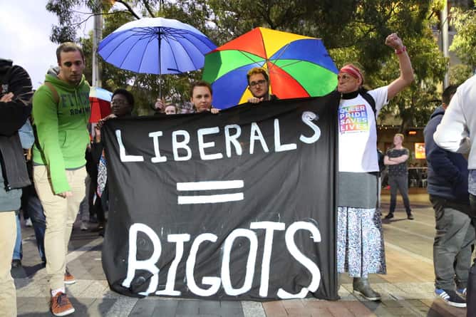 Gay rights activists hold 'Liberals = bigots' sign at a street party at Taylor Square on Oxford Street in Sydney calls on Prime Minister Malcolm Turnbull to legislate for same-sex marriage on September 23, 2015