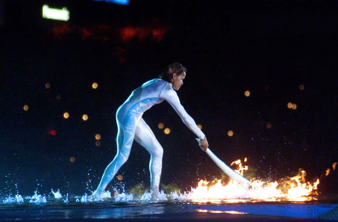 Australian Olympic athlete Cathy Freeman ignites the Olympic flame during the opening ceremony for the Summer Olympics 