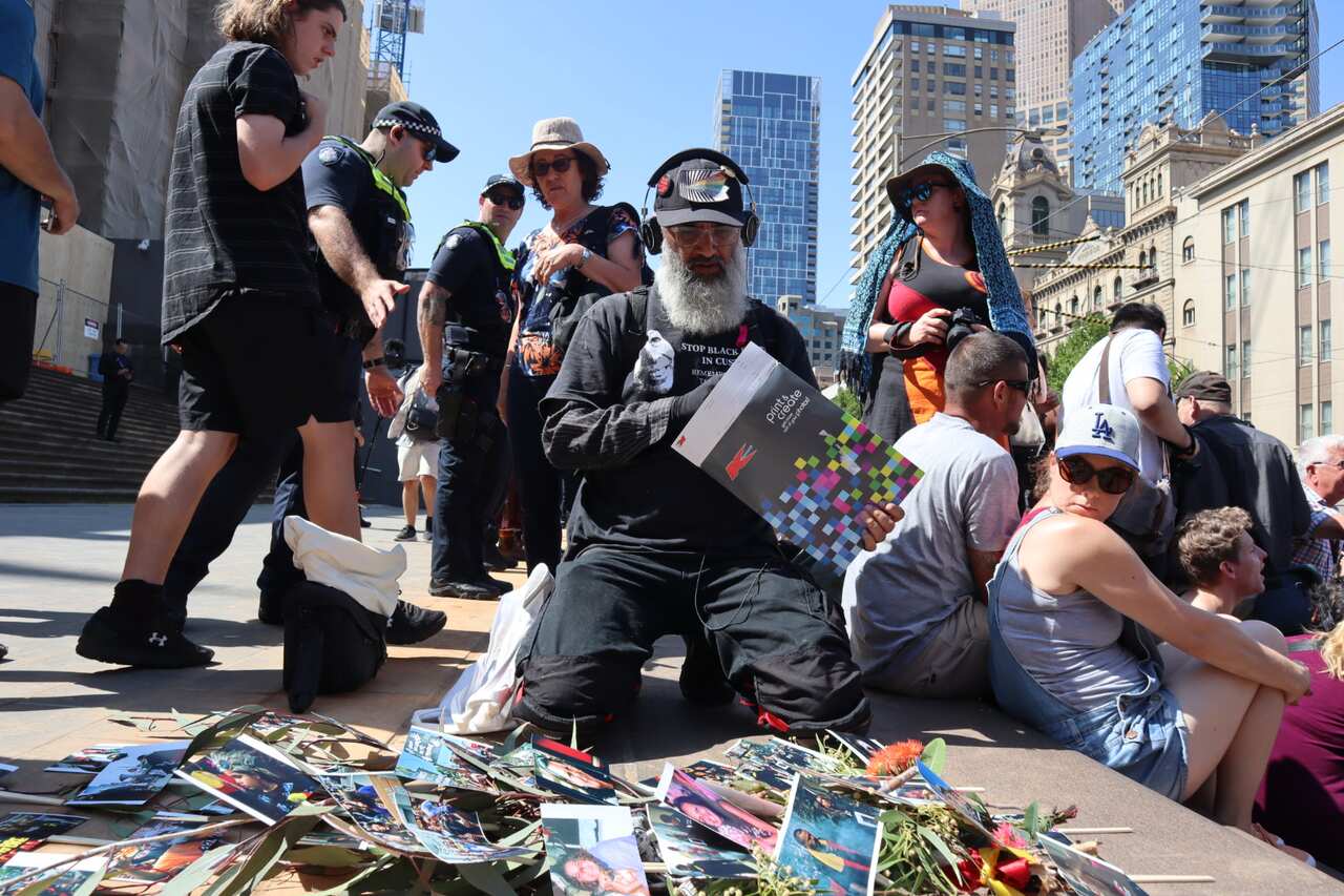 Charandev Singh lays out photos of Aboriginal people who have died in custody