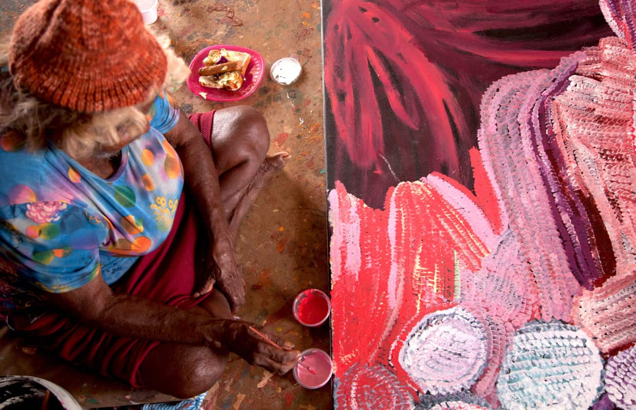 Bugai Whyoulter painting at the Martumili Artists art shed, Kunawarritji.