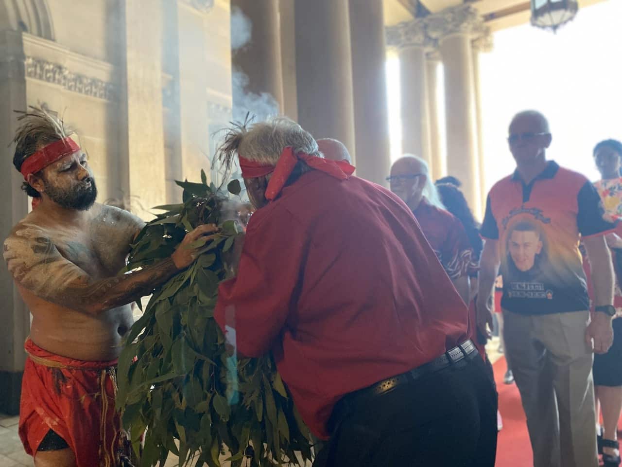 Attendants are ceremonially welcomed to Jai Wright's funeral service. 