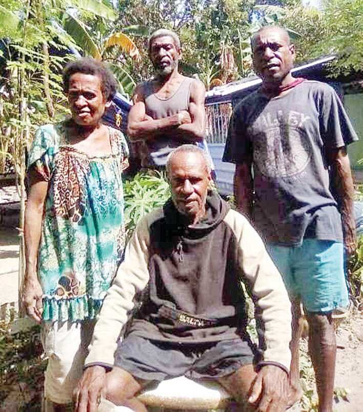Jerry Dau (sitting) with his cousins in PNG’s Mabadauan village.