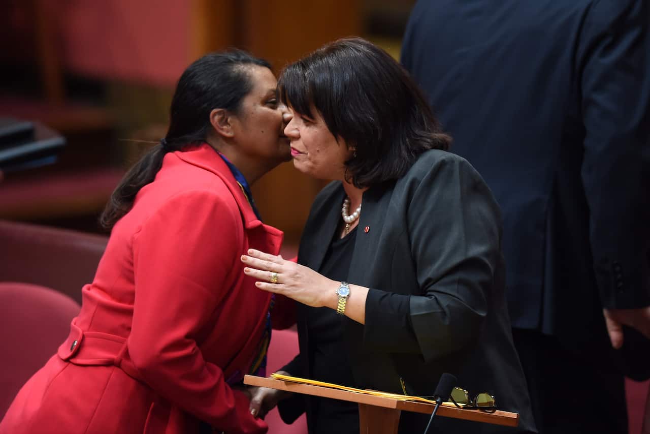 Australian Labor Senator Nova Peris congratulates Coalition Senator Joanna Lindgren after delivering her maiden speech in the Senate chamber at Parliament House in Canberra, Tuesday, Aug. 11, 2015. (AAP Image/Lukas Coch) NO ARCHIVING