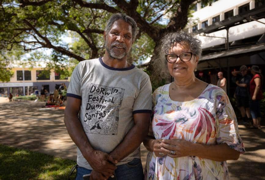 Johnny Wilson, wearing a 'Darwin festival dump santos' t-shirt, and Marie Munkarra smiling outside