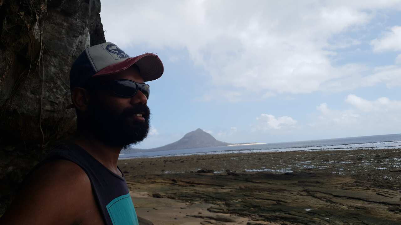 Kaleb Mabo on a beach at Mer where his grandfather's final resting place is. 