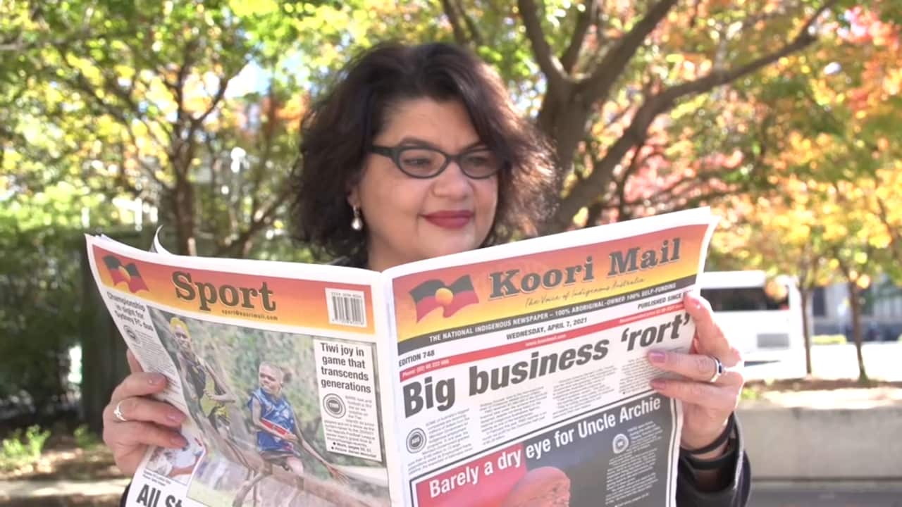 Kirstie Parker reading the Koori Mail