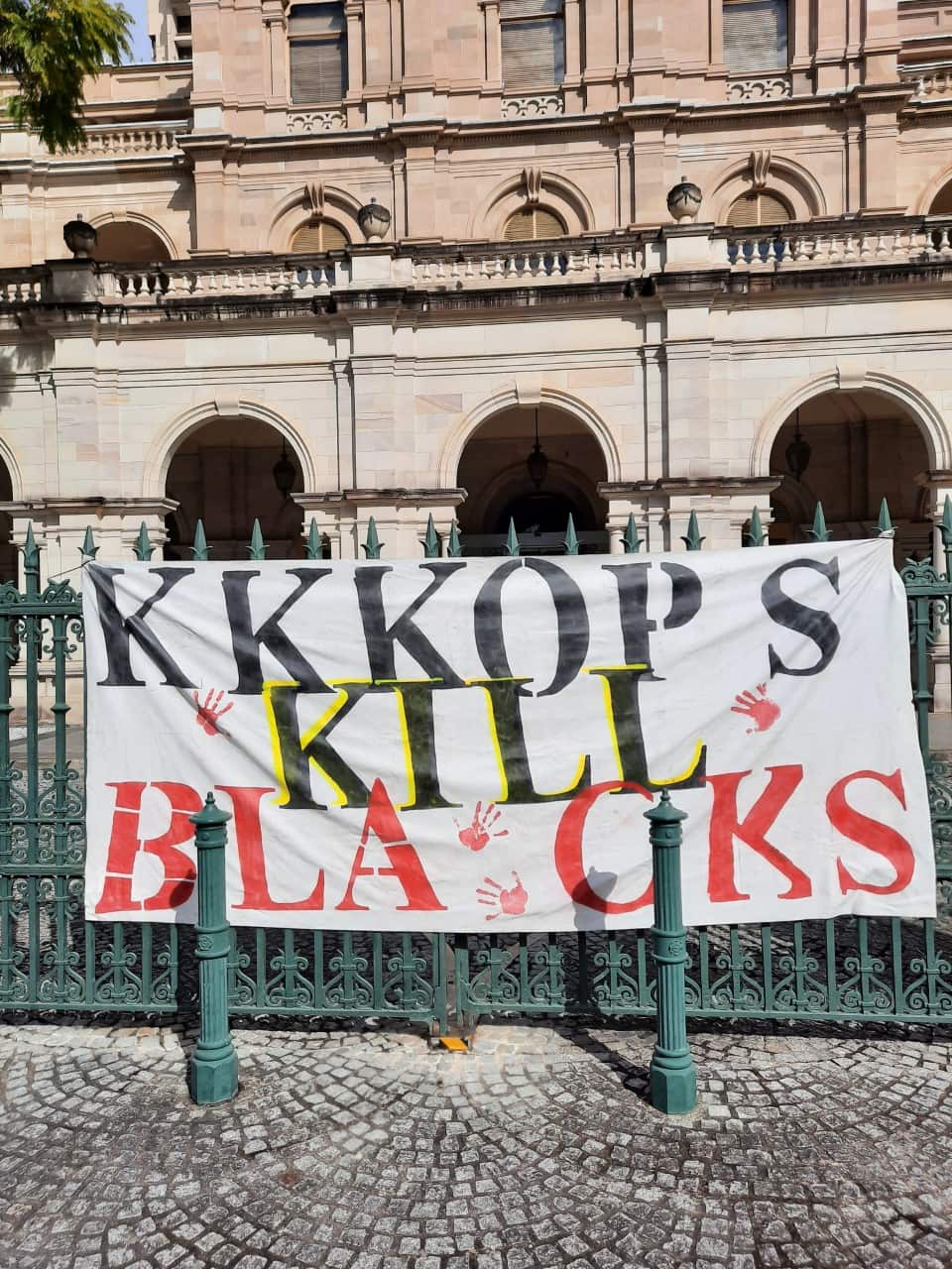 A banner hangs on the front gates of Queensland's Parliament House during a NAIDOC Week rally on the Friday, 10 July, 2020.