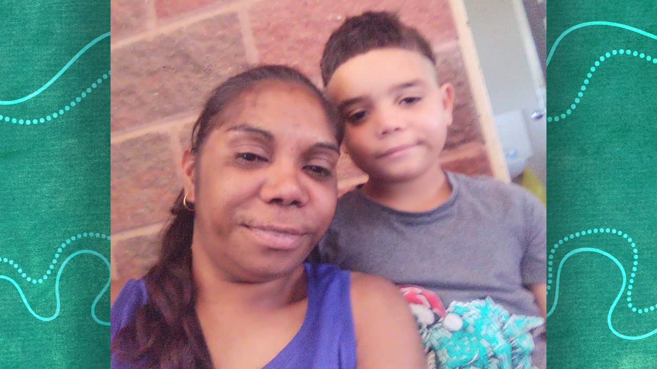 Lasonya and her son keith smile into the camera