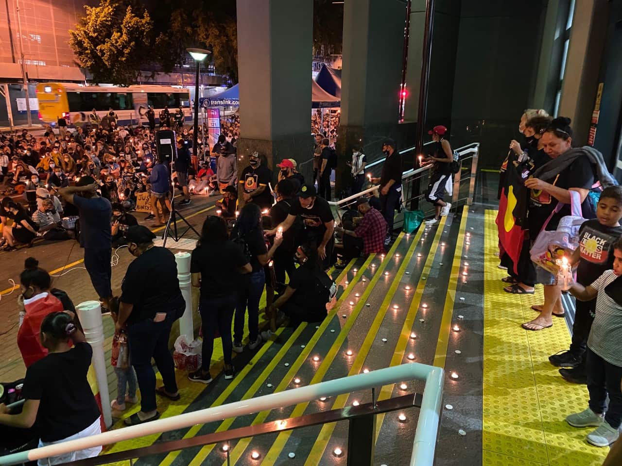 The family of Aunty Sherry Fisher-Tilberoo stand on the doorstep of QLD Police headquarters during a rally following her death in custody on September 10.