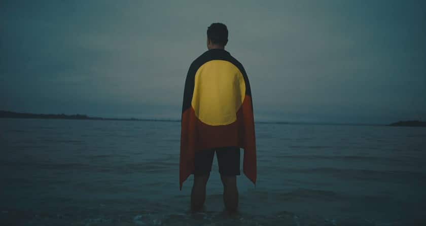 Latrell Mitchell clip from NRL advertisement 2020 draped in Aboriginal flag