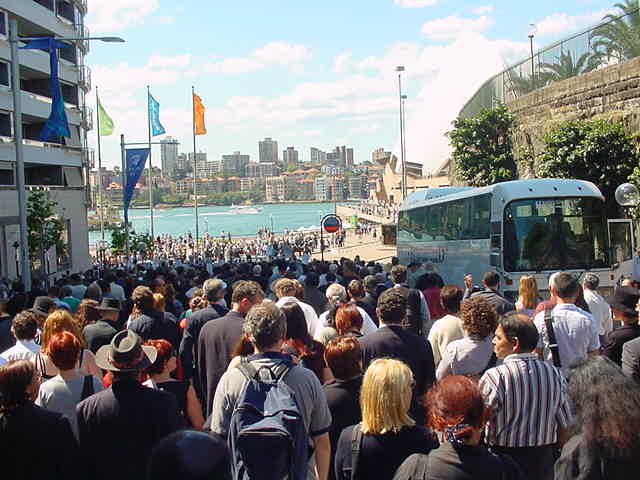 Mourners walk towards the Sydney Opera House after Charles Perkins' state funeral.
