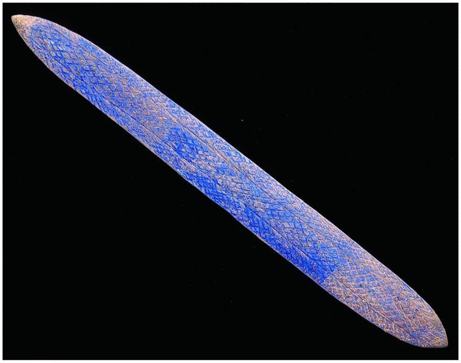 A blue message stick with complex etchings 