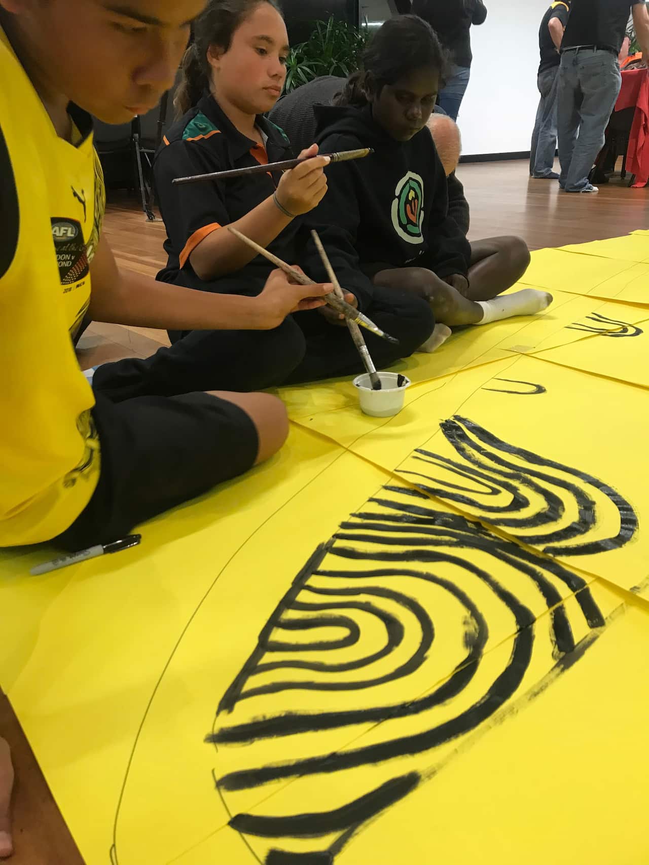 MITS Kids help create a banner.