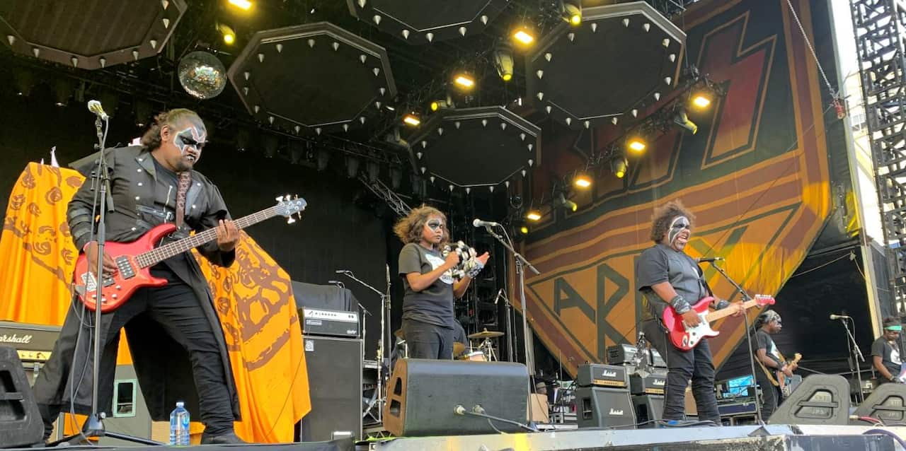 The kiss-painted boys of Mulga band perform on stage