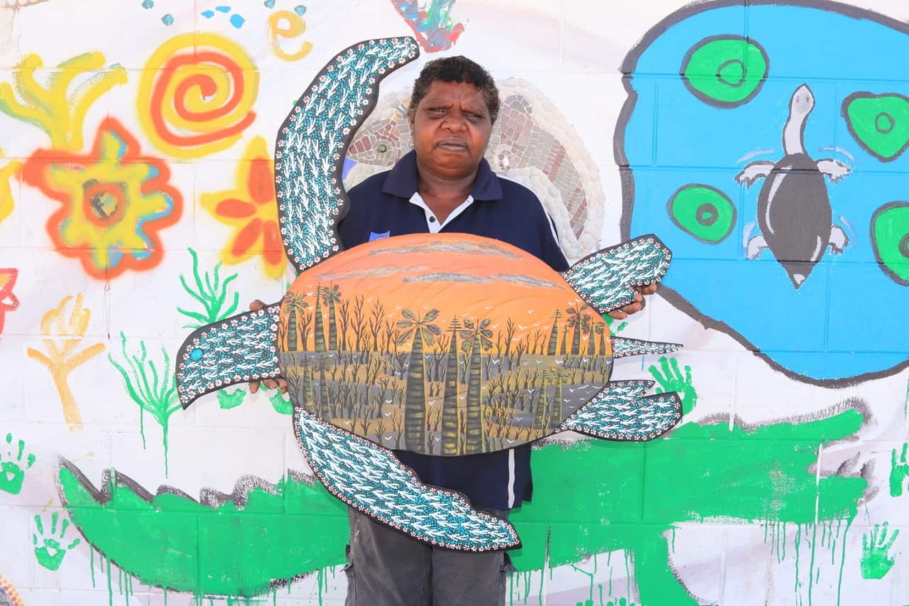 Kugu woman and artists, Mylene Holroyd holds some of her artwork, Pormpuraaw, QLD. 