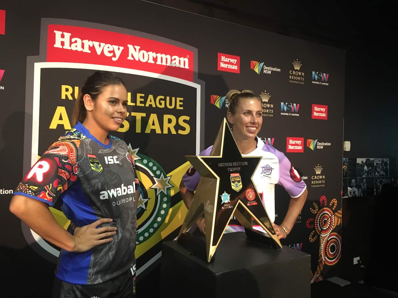 Sam Bremnar (World All Stars) and Nakia Davis-Welsh (Indigenous All Stars) with Arthur Beetson trophy. 