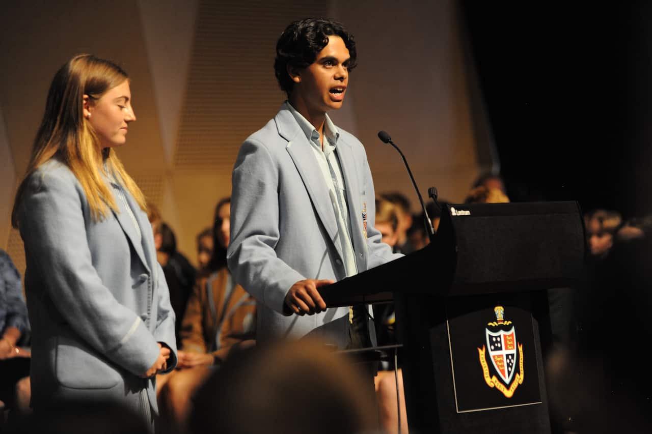 One of the Indigenous students featured in the new series Off Country, stands to speak at a school podium in uniform