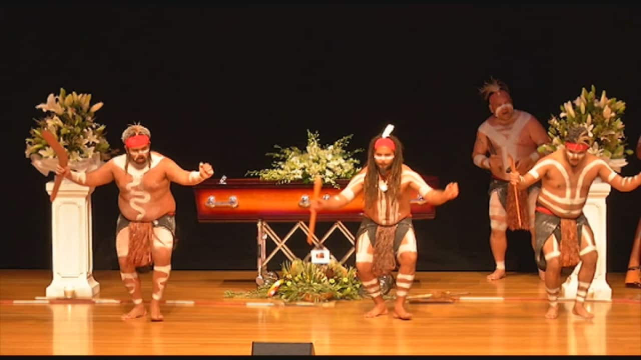 Traditional dancers at David Page's funeral service in Brisbane.
