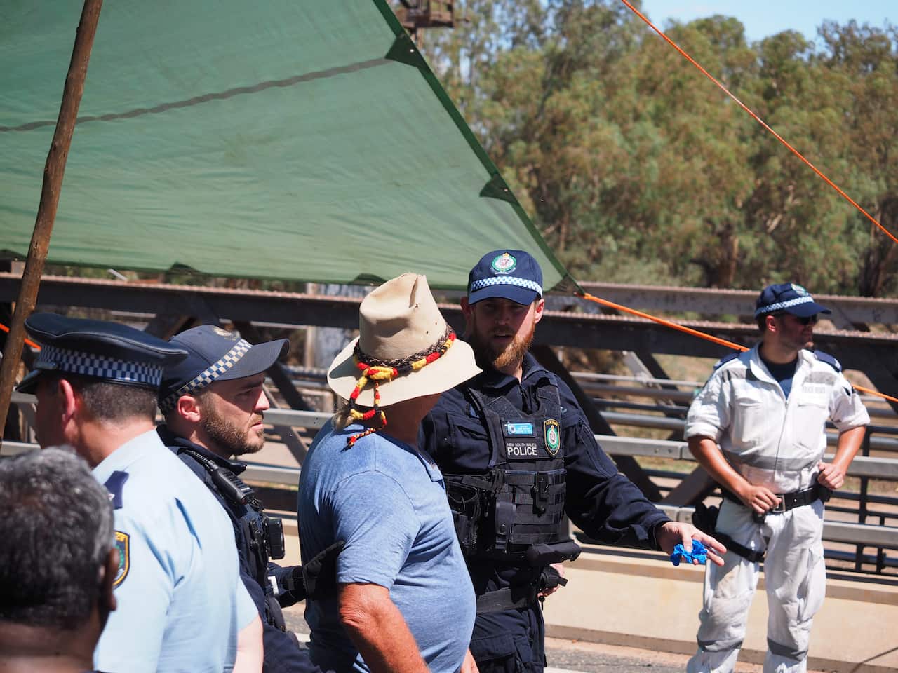 Police move protesters off Wilcannia Bridge.