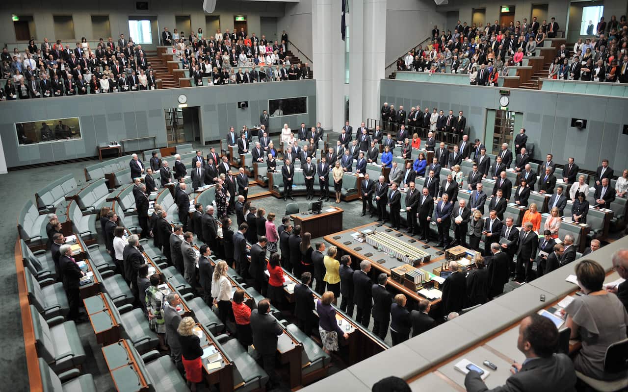 Members of the House of Representatives stand during the opening of the 44th Parliament in Canberra on November 12, 2013.    AFP PHOTO/MARK GRAHAM        (Photo credit should read MARK GRAHAM/AFP/Getty Images)
