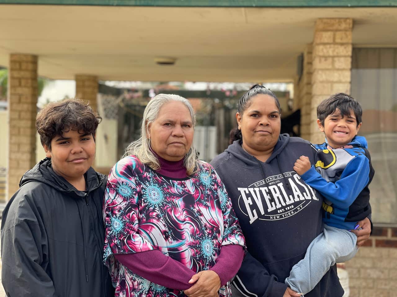 Patricia Williams with her grandchildren and daughter out the front of their home in Perth's northern suburbs. 