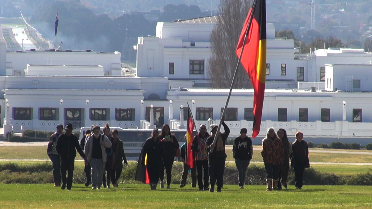 Crowd marching up to Tent Embassy 