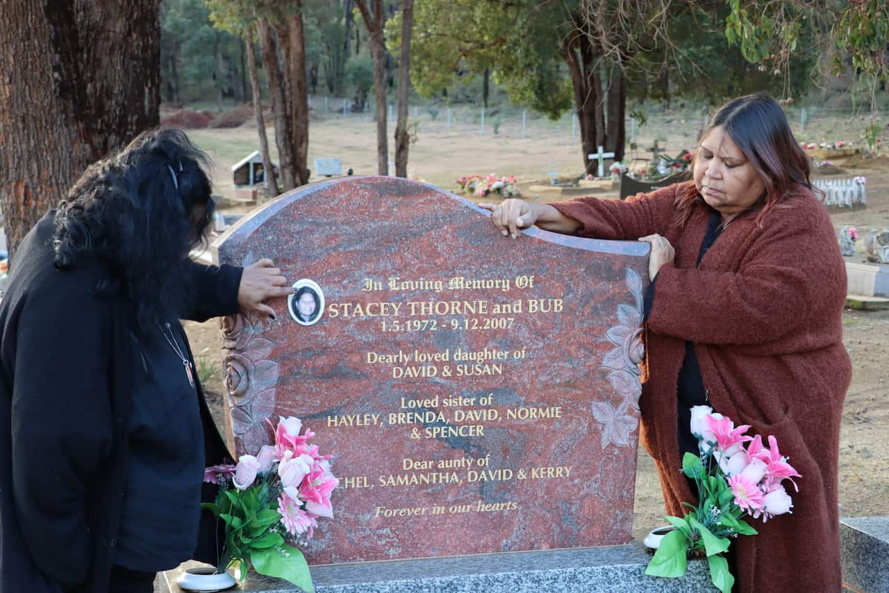 Brenda and Hayley Thorne stand beside their sister's headstone
