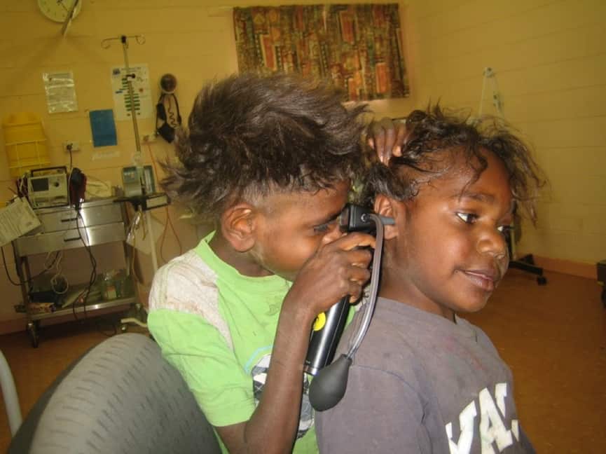 Children giving an ear exam