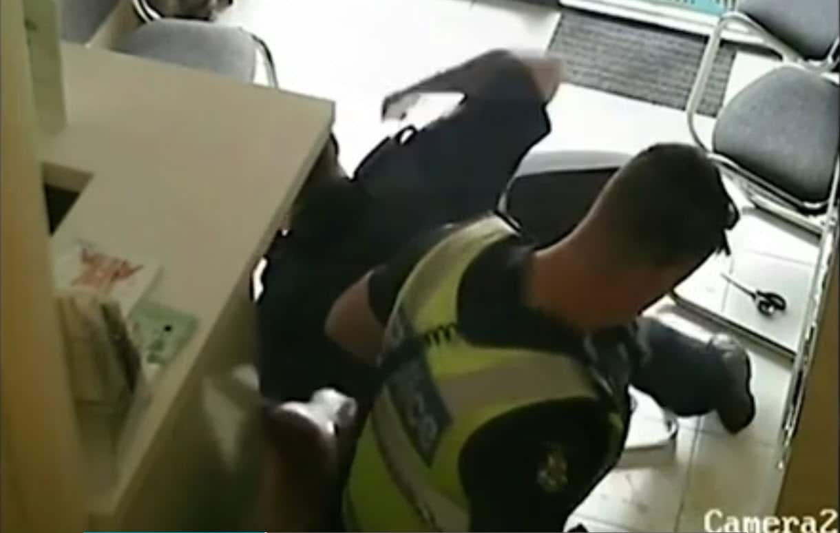 A Sudanese man is punched by a Victoria Police officer.